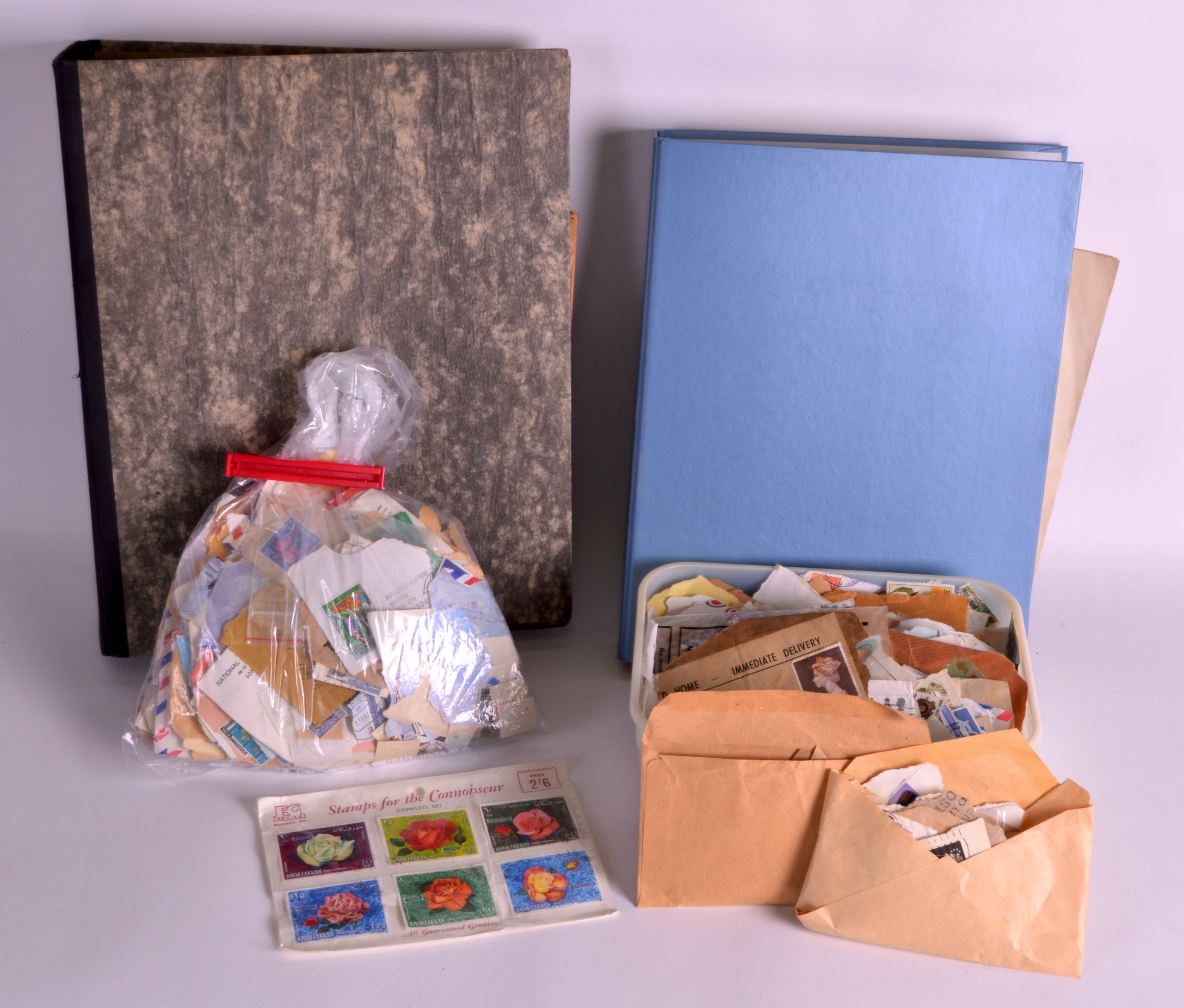 A COLLECTION OF STAMPS contained within 2 albums and also loose in boxes. (qty)