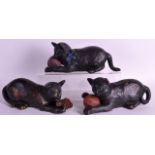 A SET OF THREE BRETBY POTTERY FIGURE OF CATS modelled clutching a ball of yarn. 10.5ins long. (3)