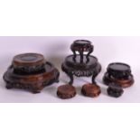 A GROUP OF NINE 19TH/20TH CENTURY CHINESE CARVED HARDWOOD STANDS of various forms and sizes. (9)