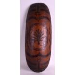 AN ABORIGINAL CARVED WOOD FACETTED SHIELD decorated all over with foliage and birds. 1Ft 11ins