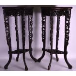 A PAIR OF 19TH CENTURY CHINESE CARVED HARDWOOD STANDS of quatrefoil form, the legs and body carved