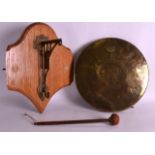 A LATE 19TH CENTURY EASTERN ENGRAVED BRASS GONG together with an Arts and Crafts wall bracket. (2)