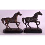 A PAIR OF SPELTER HORSES modelled upon ebonised bases. 6.75ins wide.