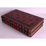 AN UNUSUAL EDWARDIAN FAUX LEATHER BACKGAMMON GAMING BOX in the form of a pair of books, with stained