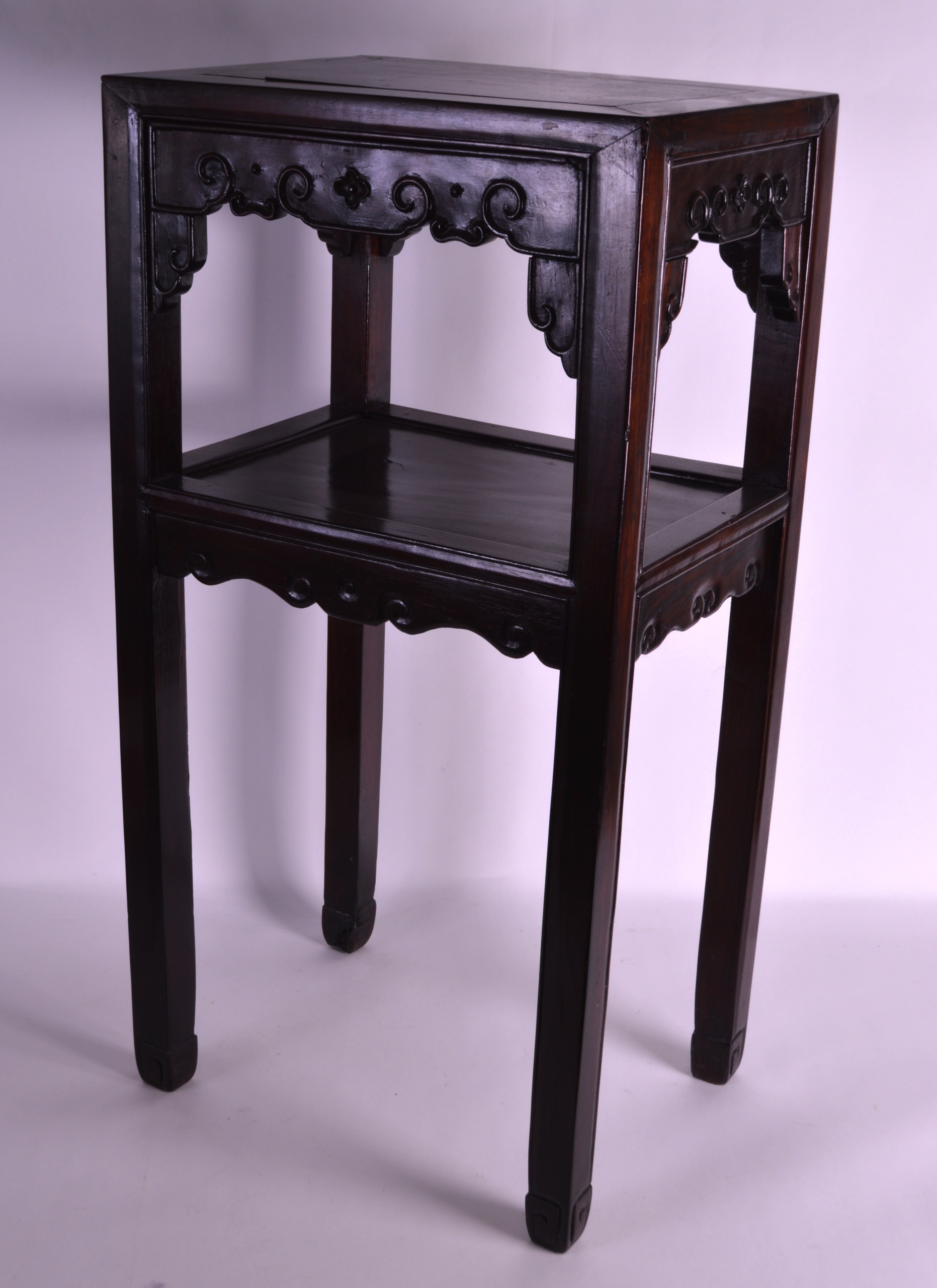 AN EARLY 20TH CENTURY CHINESE CARVED HARDWOOD RECTANGULAR STAND with square legs and floral