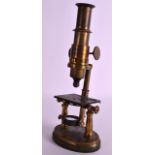 A SMALL LATE VICTORIAN BRONZE MICROSCOPE with swivel action and oval base. 9.75ins high.