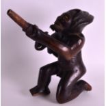 AN UNUSUAL EARLY 20TH CENTURY AFRICAN CARVED TRIBAL HARDWOOD FIGURE depicting a male holding a