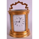 A LATE 19TH/20TH CENTURY FRENCH OVAL BRASS CARIAGE CLOCK with white dial and black painted numerals.