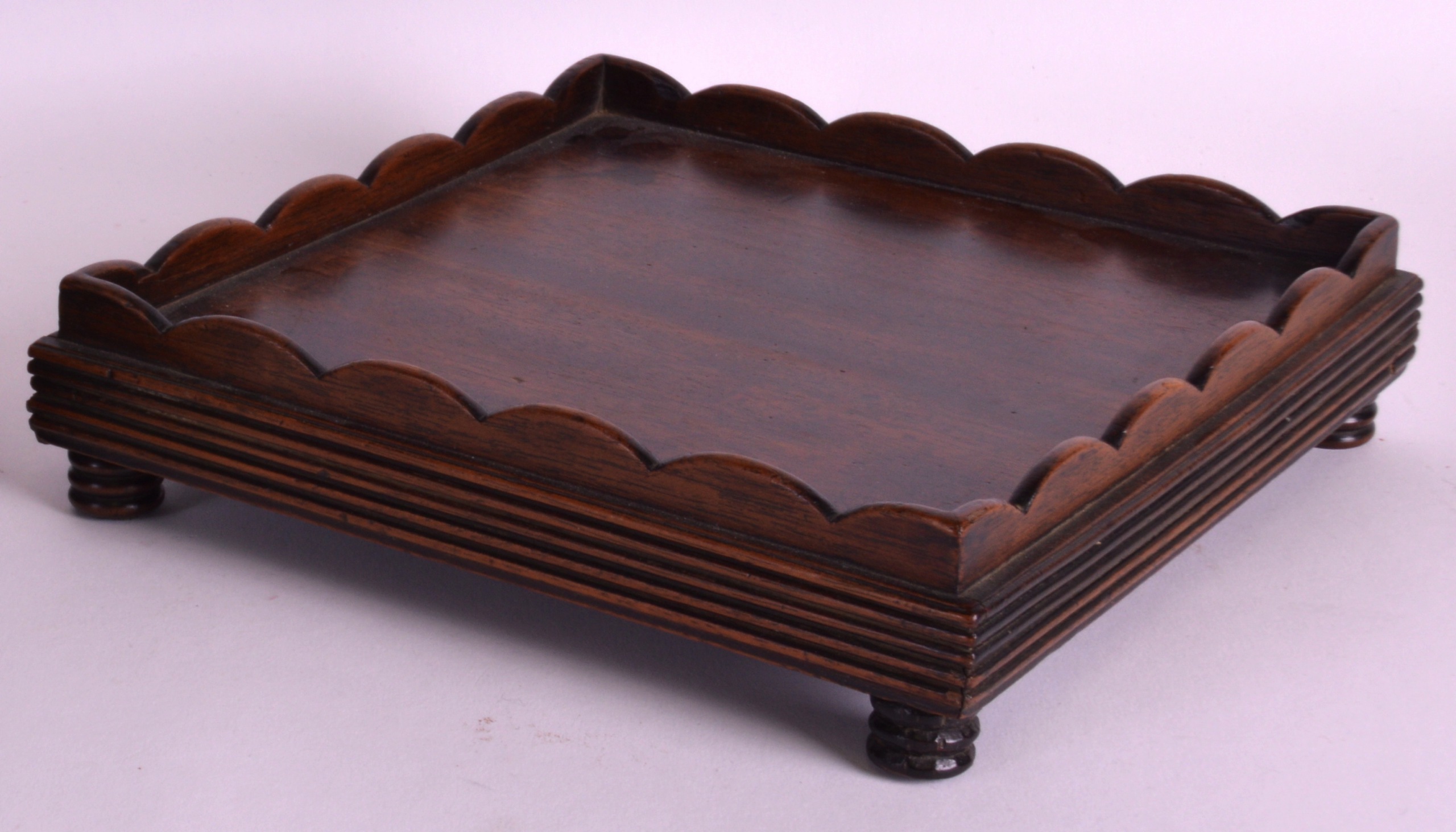 A LATE 19TH CENTURY JAPANESE CARVED HARDWOOD STAND of square form. 8.25ins wide.