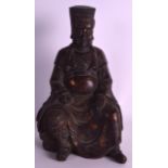 A CHINESE BRONZE FIGURE OF A SEATED SCHOLAR with lacquer remnants, modelled with one hand