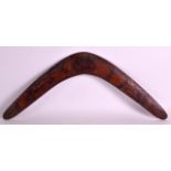 AN ABORIGINAL CARVED WOOD BOOMERANG decorated all over with hunters, ostrich and kangaroos. 1Ft 9ins