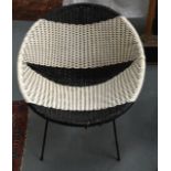 A 1970S BLACK AND WHITE CHAIR.