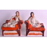 A PAIR OF STAFFORDSHIRE MODELS OF RECLINING FIGURES modelled upon chaise lounges. 7.5ins wide.