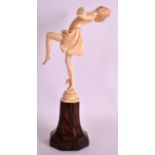 A FINE EARLY 20TH CENTURY ART DECO CARVED IVORY FIGURE OF A FLAPPER modelled with arms outstretched,