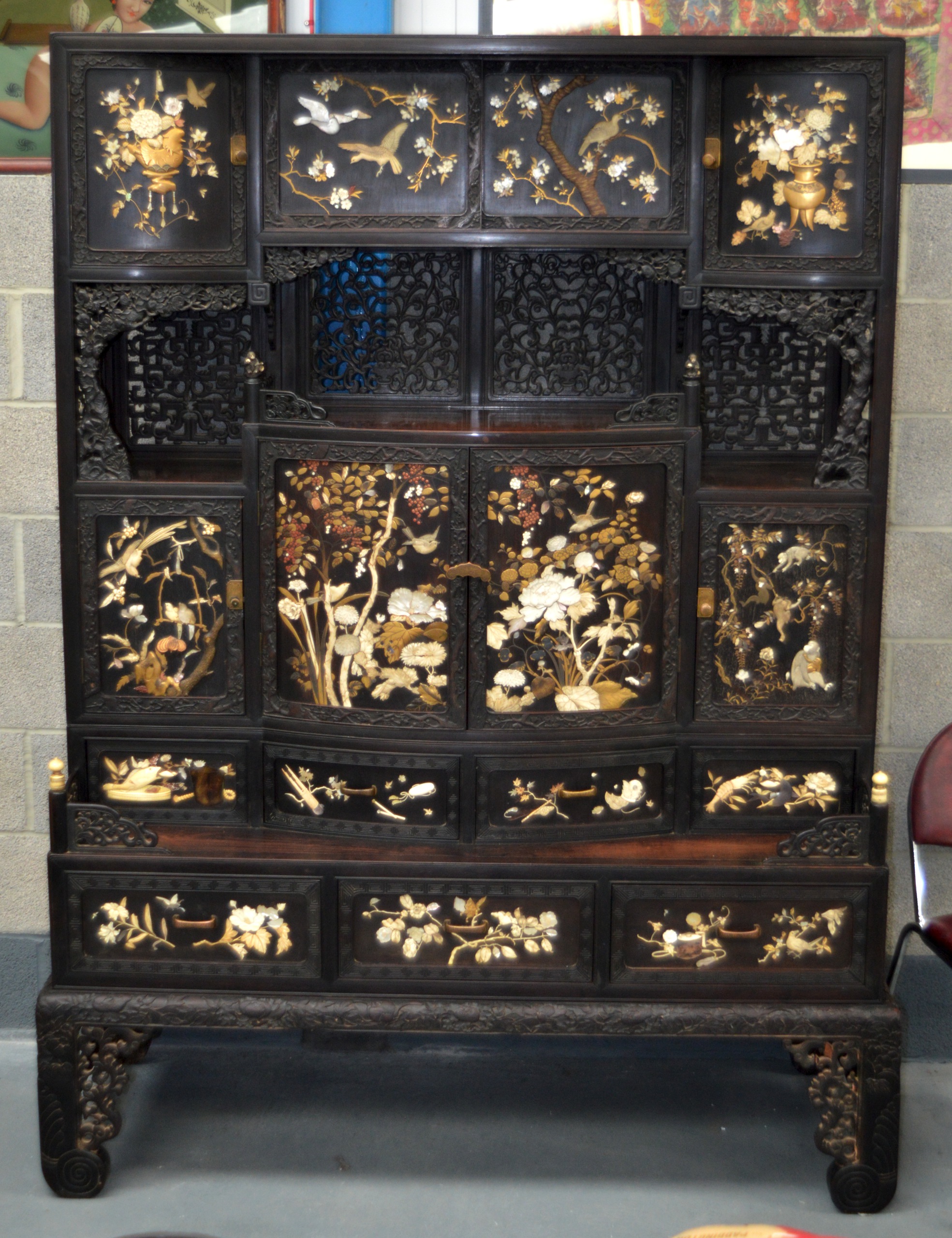 A SUPERB LATE 19TH CENTURY JAPANESE CARVED HARDWOOD SHIBAYAMA CABINET wonderfully executed with