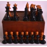 AN EARLY 20TH CENTURY BOXWOOD CHESS SET contained within a turned wood box. (qty)