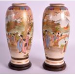 A PAIR OF EARLY 20TH CENTURY JAPANESE TAISHO PERIOD SATSUMA VASES painted with geishas within