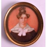 A LATE 19TH CENTURY PAINTED PORTRAIT IVORY MINIATURE depicting a female within a peach interior.