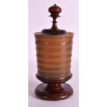 A 19TH CENTURY EUROPEAN CARVED HORN VASE AND COVER with turned wood handle and base. 9.5ins high.