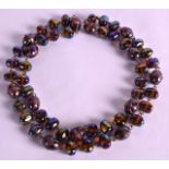 A VINTAGE IRIDESCENT LADIES GLASS NECKLACE. Overall 3ft long.