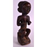 AN EARLY 20TH CENTURY AFRICAN CARVED HARDWOOD FERTILITY FIGURE depicting a female cupping her
