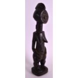 AN EARLY 20TH CENTURY AFRICAN CARVED HARDWOOD FERTILITY FIGURE. 9.75ins high.