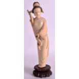 AN EARLY 20TH CENTURY CHINESE CARVED IVORY FIGURE OF GUANYIN modelled holding a fish in one hand.