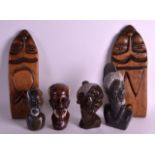 A SET OF FOUR MID 20TH CENTURY CARVED AFRICAN STONE HEADS together with a pair of wooden panels. (