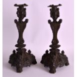A PAIR OF EARLY 19TH CENTURY EUROPEAN BRONZE CANDLESTICKS with figural scones and caryatid mounts