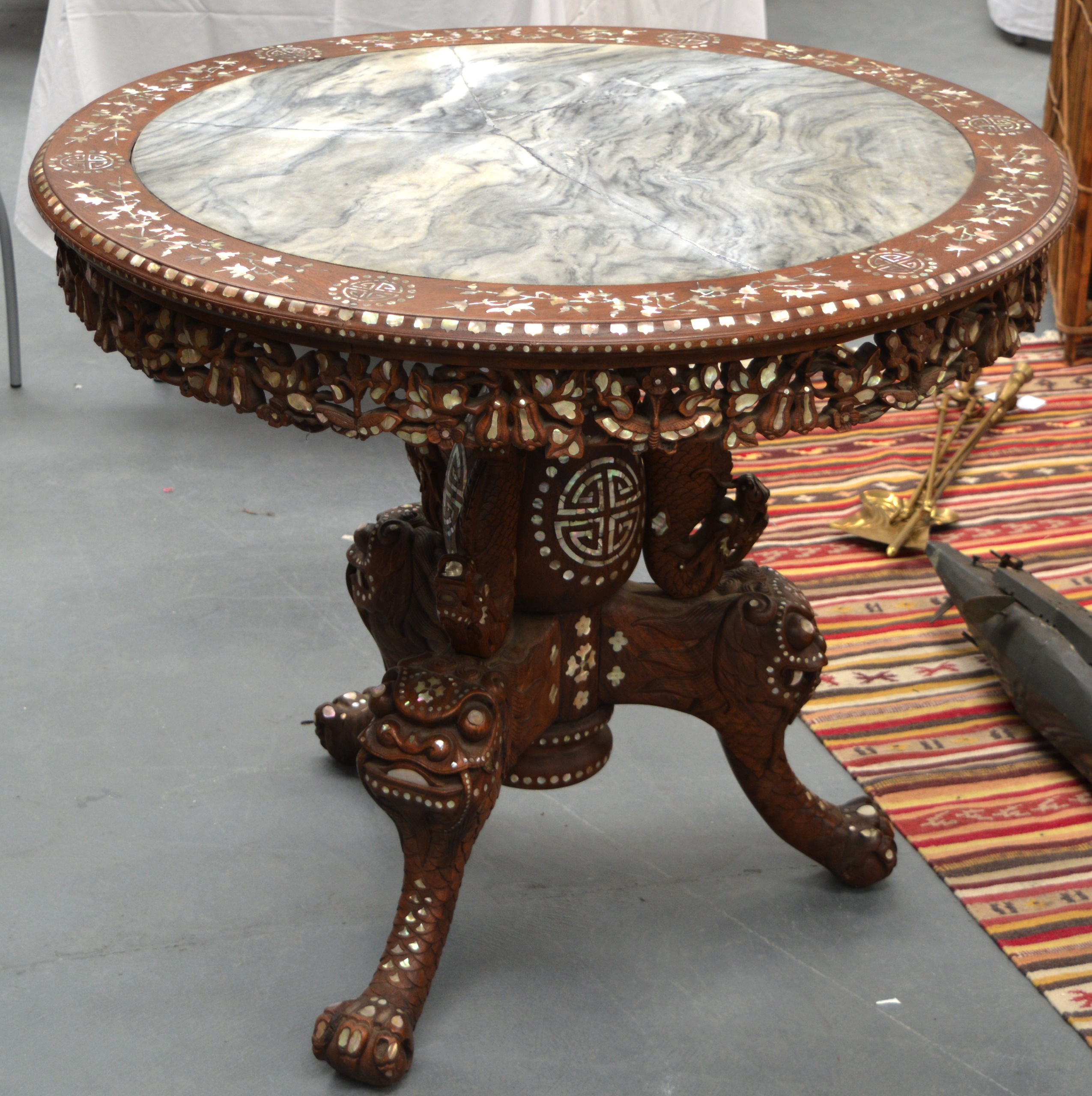 A GOOD 19TH CENTURY CHINESE CARVED HARDWOOD AND MOTHER OF PEARL CENTRE TABLE supported on boldly