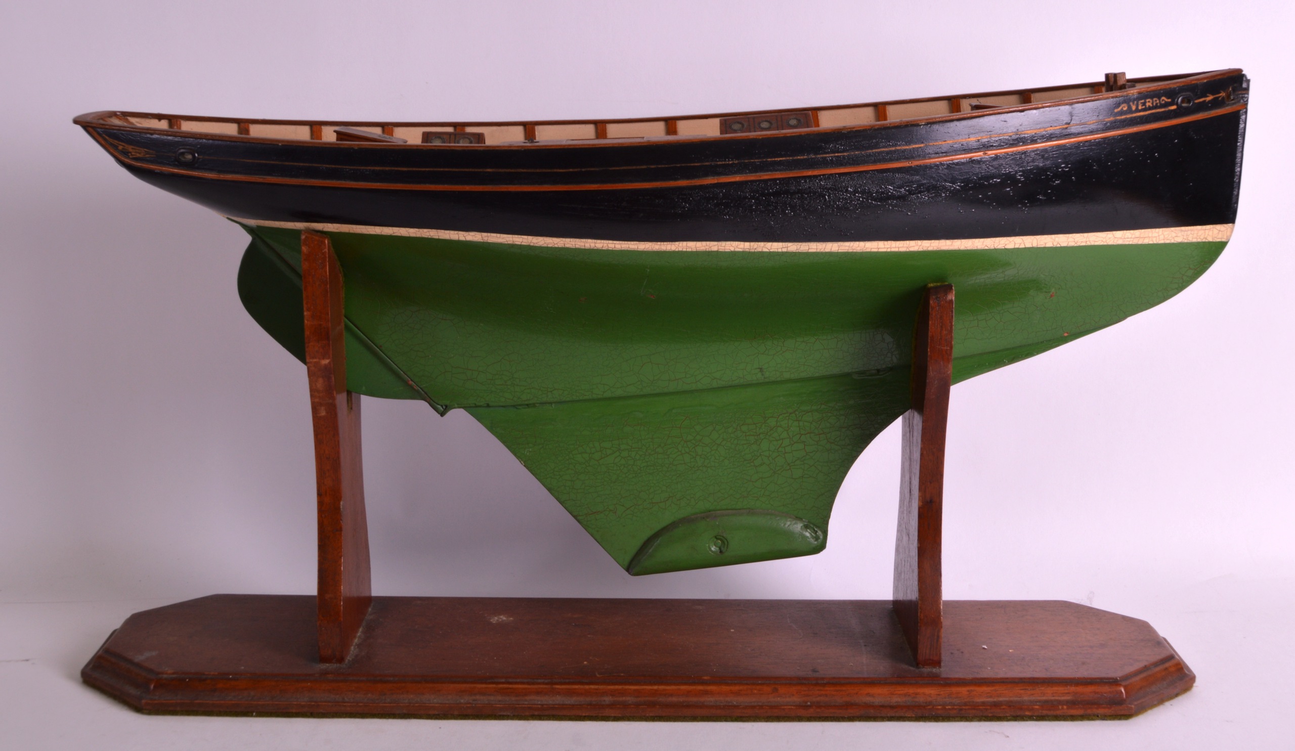 A LARGE EARLY 20TH CENTURY PAINTED AND LACQUERED WOOD BOAT named 'Vera' supported upon an oak