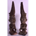 A PAIR OF EARLY 20TH CENTURY SUMATRAN FIGURES Toba Batak people, modelled with long head pieces. 1Ft