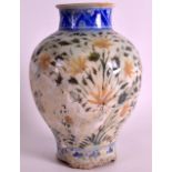 A 17TH CENTURY PERSIAN SAFAVID VASE painted with flowers. 7.75ins high.