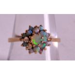 AN EDWARDIAN 9CT YELLOW GOLD AND OPAL CLUSTER RING.