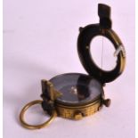 A SMALL EARLY 20TH CENTURY BRASS MILITARY COMPASS with unusual iridescent shell dial. 2.25ins