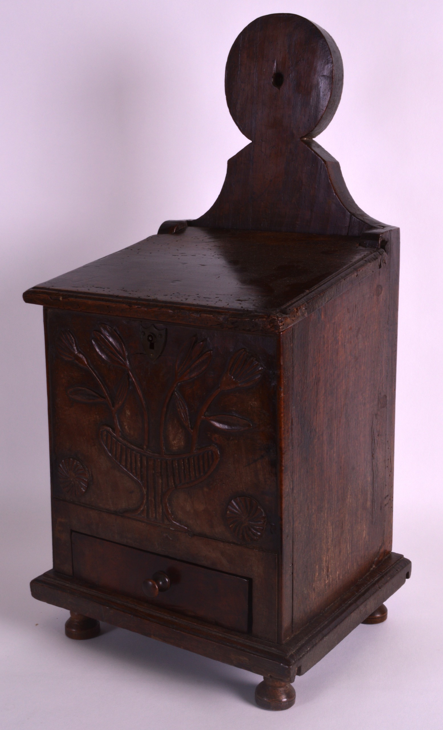A GOOD 18TH CENTURY OAK SALT BOX carved with a central urn with extensive foliage. 1Ft 9ins high.