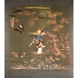 AN EARLY 20TH CENTURY CHINESE FRAMED GREEN SILKWORK PANEL depicting a figure beside fish,