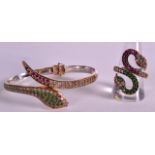 A SILVER RUBY AND EMERALD SNAKE BANGLE and matching ring. (2)