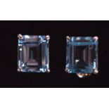 A PAIR OF SILVER EMERALD CUT BLUE TOPAZ EARRINGS.