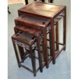 A NEST OF FOUR CHINESE CARVED HARDWOOD TABLES. Largest 2ft 4ins high. (4)