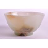 AN EARLY 20TH CENTURY CHINESE CARVED GREEN JADE BOWL of flared form, with natural inclusions. 3.