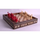 A MID 19TH CENTURY ANGLO INDIAN CARVED AND STAINED IVORY CHESS SET contained upon a mosaic inlaid