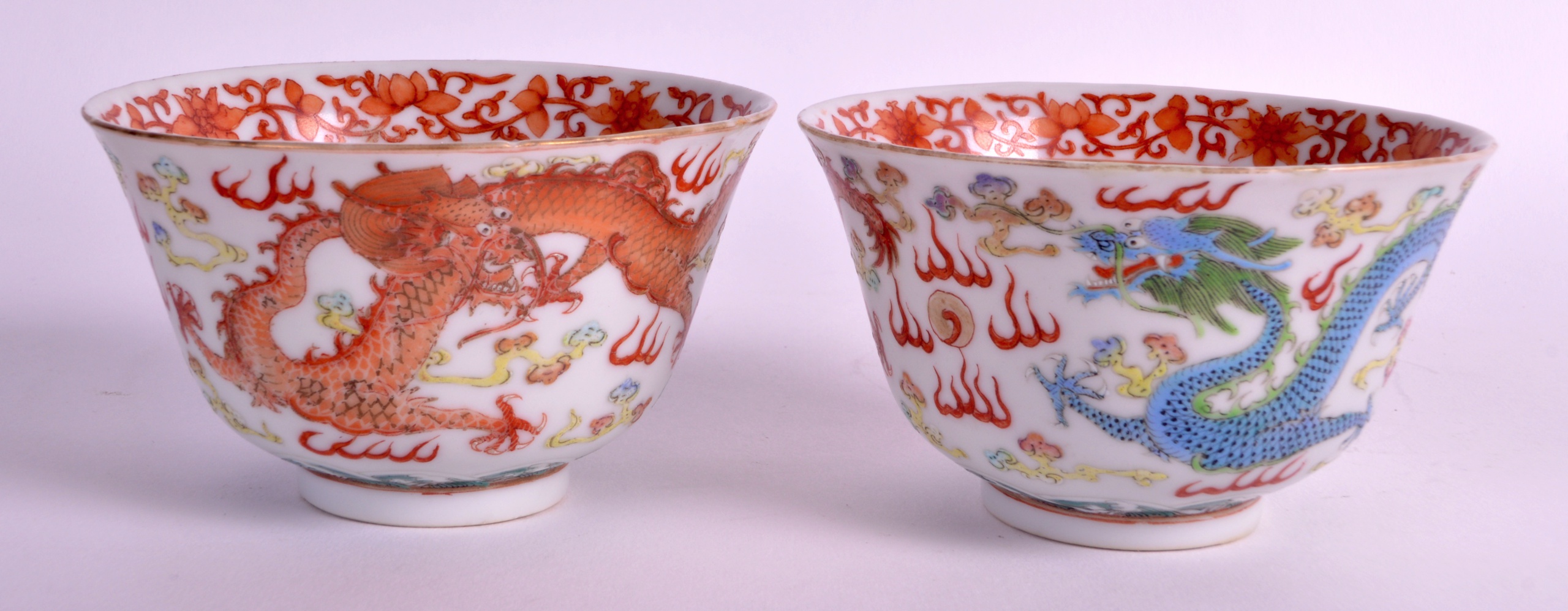 A PAIR OF EARLY 20TH CENTURY CHINESE FAMILLE ROSE BOWLS painted with dragons amongst clouds. 4Ins