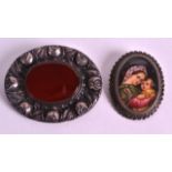 A 19TH CENTURY CONTINENTAL SILVER AND AGATE BROOCH together with another smaller silver brooch. (2)