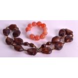 A CHINESE CARVED GENTLEMANS AGATE BRACELET together with an amber type naturalistic necklace. (2)