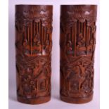 A PAIR OF EARLY 20TH CENTURY CHINESE CARVED BAMBOO BRUSH POTS Qing, decorated with scholars under