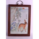 A CHINESE FAMILLE ROSE PORCELAIN PLAQUE Qing/Republic, painted with a spotted deer standing beside