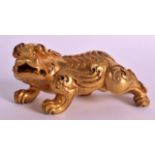 A CHINESE QING DYNASTY GILT BRONZE MODEL OF A BUDDHISTIC LION modelled prowling, with incised