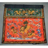 A LATE 19TH CENTURY CHINESE RED SILKWORK HANGING PANEL unusually depicting buddhistic lions and