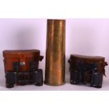 A WWII SHELL CASE together with two pairs of vintage binoculars. (3)